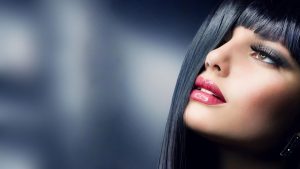 Glamorous woman with glossy lips and long eyelashes